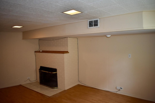 33 N Spring Ave, La Grange, IL 60525 - finished basement with light wood finished floors and a brick fireplace