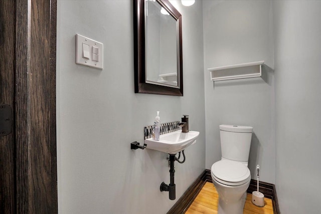 1331 W Granville Ave, Chicago, IL 60660 - half bath with baseboards, wood finished floors, and toilet