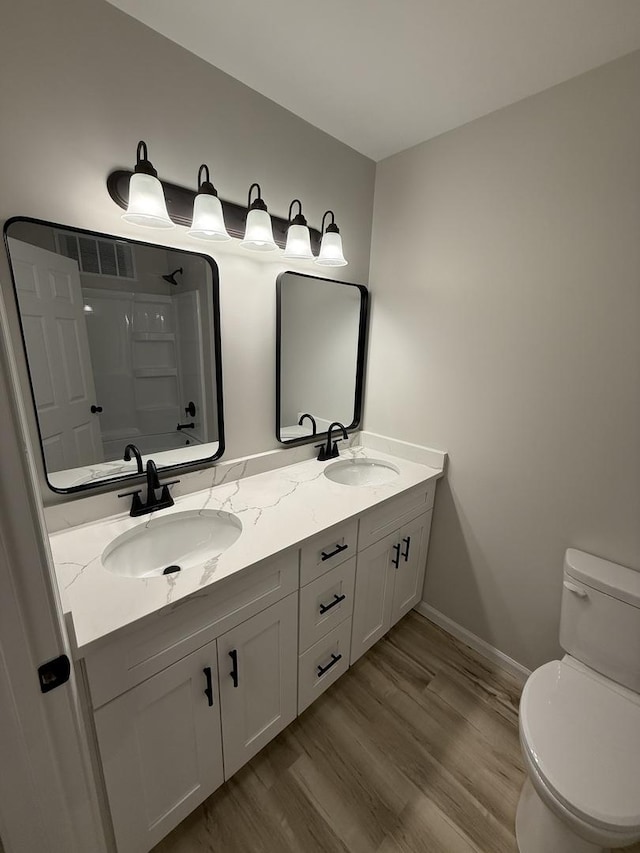405 9th St, Mazon, IL 60444 - bathroom with toilet, walk in shower, a sink, and wood finished floors