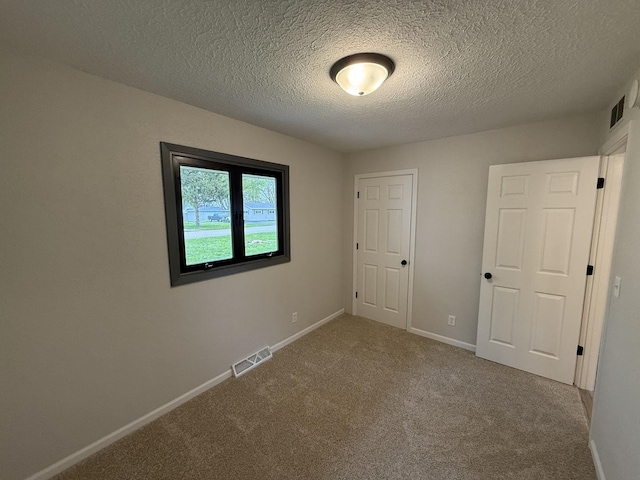 405 9th St, Mazon, IL 60444 - empty room with visible vents, carpet flooring, a textured ceiling, and baseboards