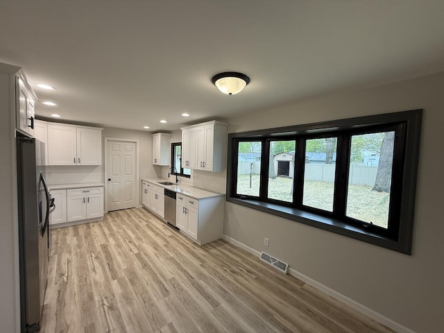 405 9th St, Mazon, IL 60444 - kitchen featuring a sink, stainless steel appliances, baseboards, recessed lighting, and visible vents