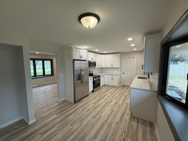 405 9th St, Mazon, IL 60444 - kitchen featuring baseboards, recessed lighting, a sink, light wood-style flooring, and stainless steel appliances