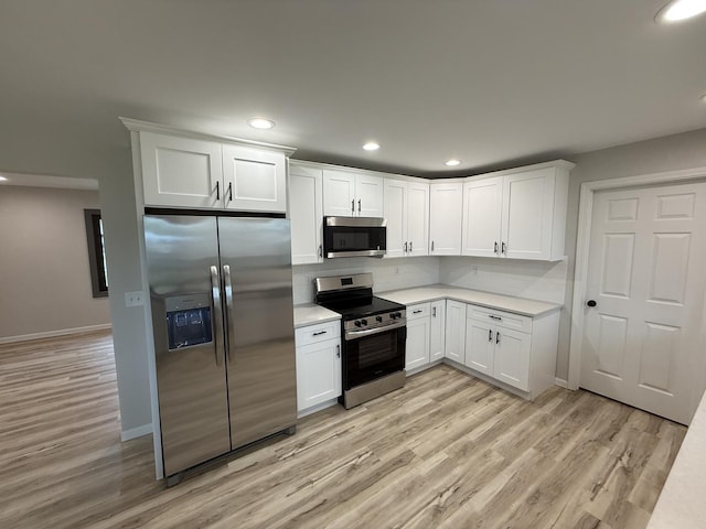 405 9th St, Mazon, IL 60444 - kitchen featuring light countertops, appliances with stainless steel finishes, white cabinets, and light wood-type flooring