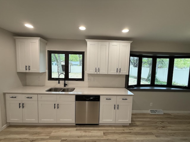 405 9th St, Mazon, IL 60444 - kitchen with visible vents, a sink, dishwasher, and white cabinets