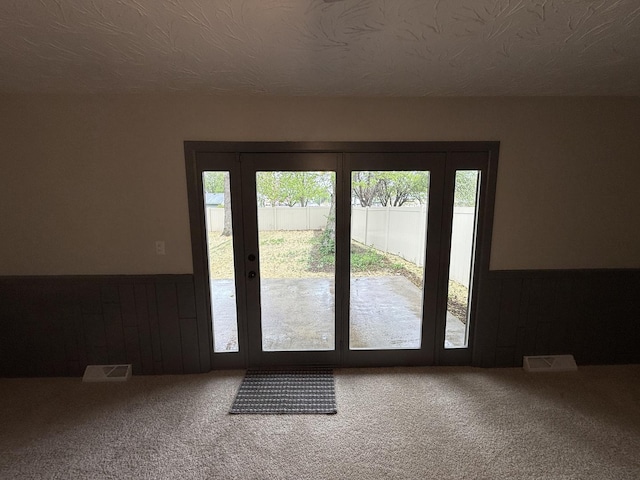 405 9th St, Mazon, IL 60444 - doorway with a healthy amount of sunlight, carpet, wainscoting, and visible vents