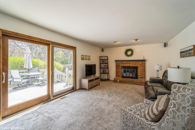 carpeted living room featuring visible vents and a fireplace