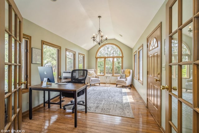 office with an inviting chandelier, lofted ceiling, a healthy amount of sunlight, and light wood-type flooring