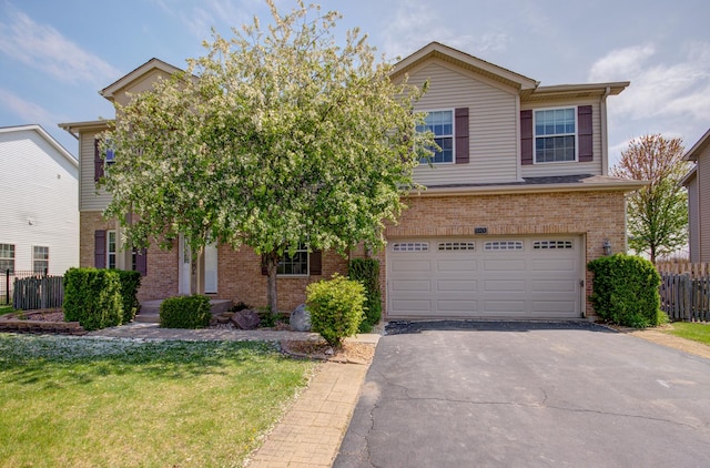 1120 Redwood Ln, Minooka, IL 60447 - view of front of property featuring brick siding, an attached garage, fence, and aphalt driveway