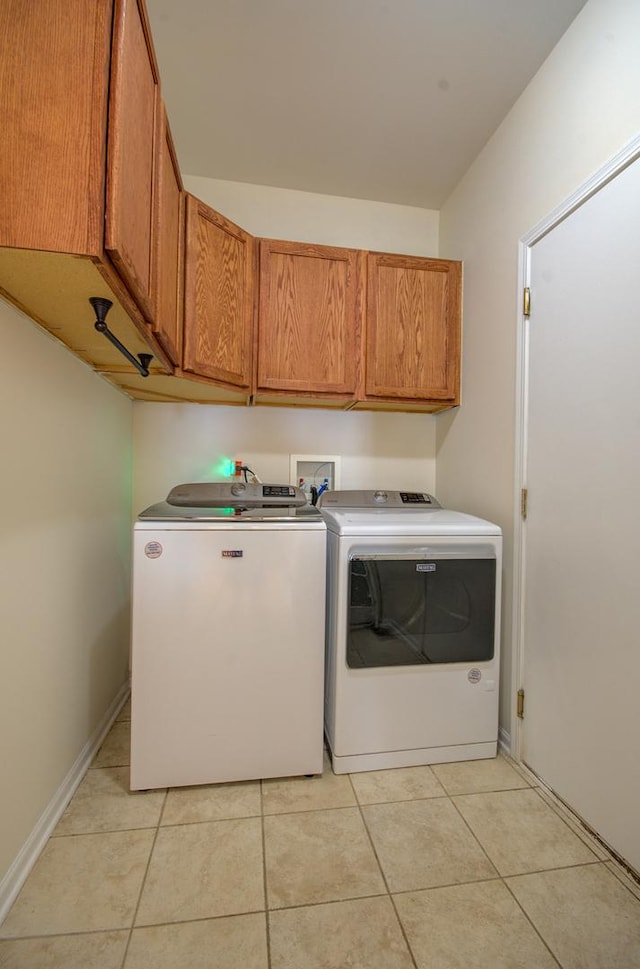 1120 Redwood Ln, Minooka, IL 60447 - laundry room with baseboards, washer and clothes dryer, cabinet space, and light tile patterned floors