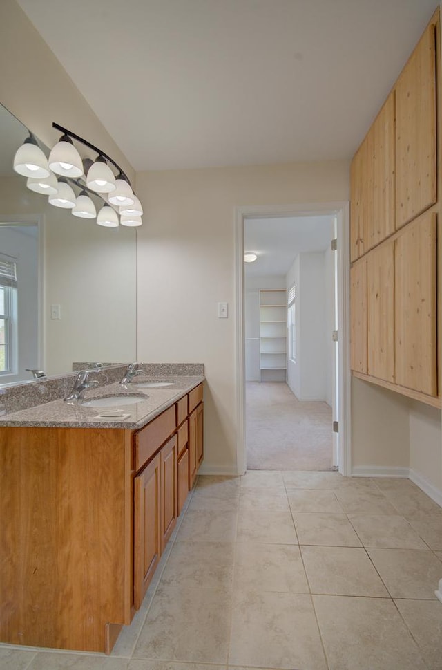 1120 Redwood Ln, Minooka, IL 60447 - bathroom featuring baseboards, tile patterned flooring, and vanity