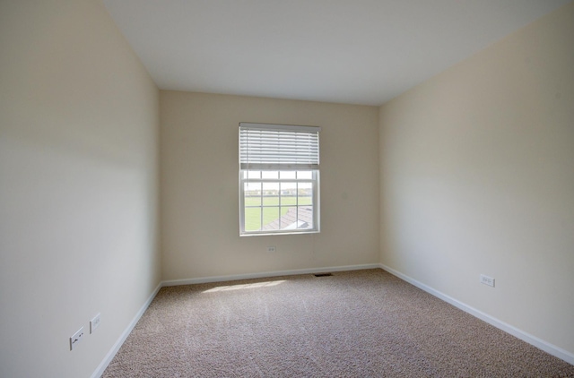 1120 Redwood Ln, Minooka, IL 60447 - empty room with carpet floors, baseboards, and visible vents
