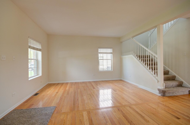 1120 Redwood Ln, Minooka, IL 60447 - unfurnished room featuring visible vents, plenty of natural light, and wood finished floors
