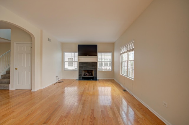 1120 Redwood Ln, Minooka, IL 60447 - unfurnished living room with light wood-style floors, baseboards, a fireplace, and stairway