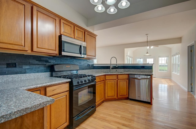 1120 Redwood Ln, Minooka, IL 60447 - kitchen featuring brown cabinetry, a peninsula, tasteful backsplash, a sink, and stainless steel appliances
