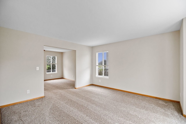 carpeted spare room with baseboards