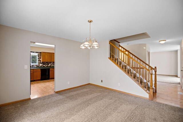 unfurnished room with an inviting chandelier, baseboards, stairs, and light carpet