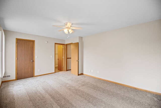 unfurnished bedroom with visible vents, a ceiling fan, baseboards, and carpet floors