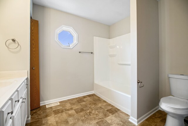 full bathroom with shower / bath combination, visible vents, vanity, baseboards, and toilet