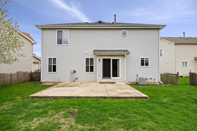 back of house with a lawn, a patio, central AC, and fence