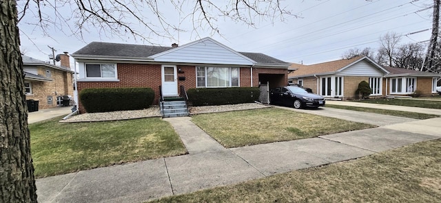bungalow featuring a shingled roof, an attached garage, a front lawn, brick siding, and concrete driveway