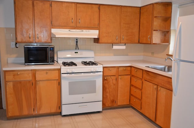 kitchen featuring open shelves, white appliances, light countertops, under cabinet range hood, and a sink