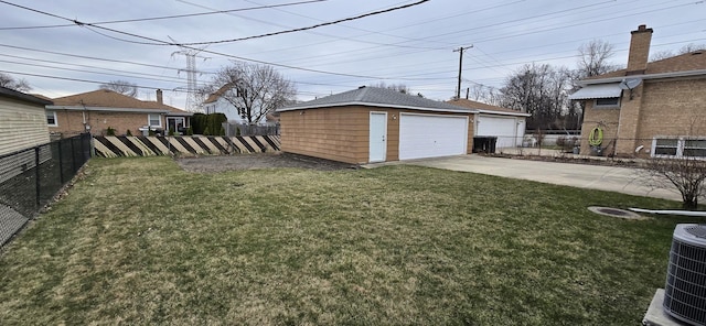 view of yard featuring central air condition unit, fence, an outbuilding, and a garage