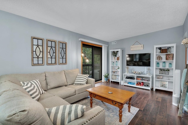 living room with a textured ceiling and wood finished floors