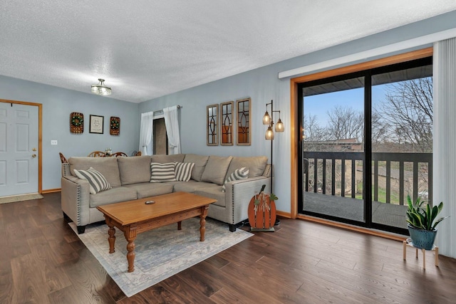 living room with baseboards, a textured ceiling, and dark wood-type flooring