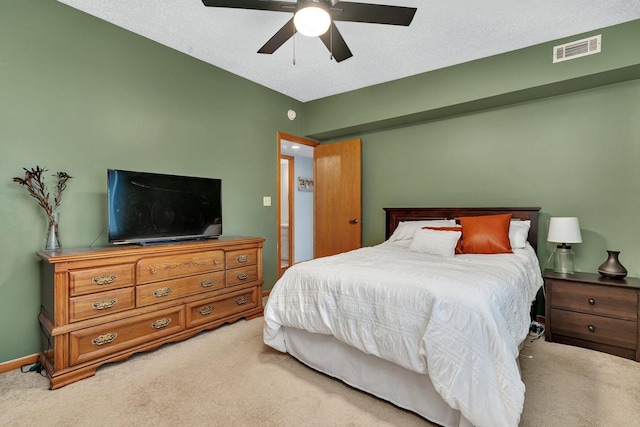 bedroom featuring a ceiling fan, baseboards, visible vents, and light carpet