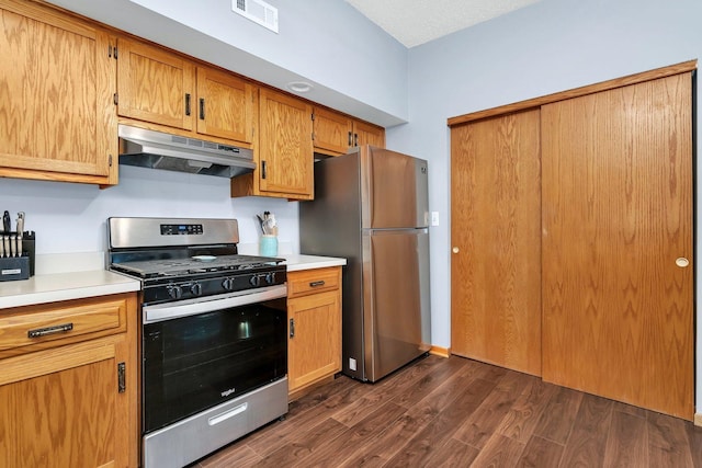 kitchen with under cabinet range hood, stainless steel appliances, visible vents, and light countertops