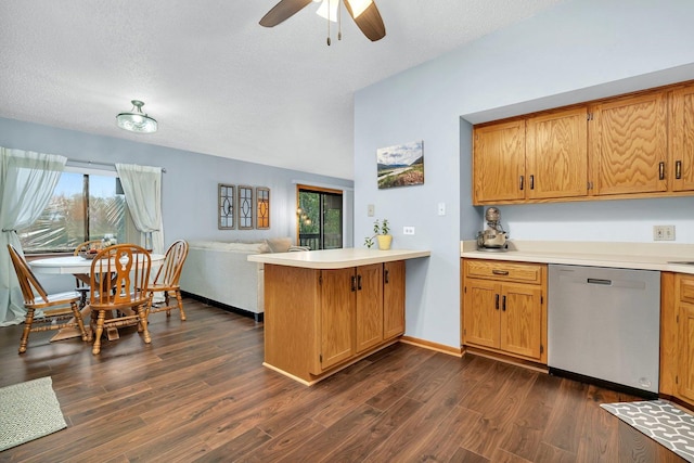 kitchen with stainless steel dishwasher, dark wood finished floors, light countertops, a peninsula, and open floor plan