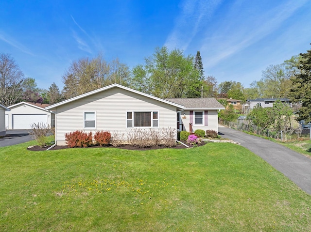 single story home with an outbuilding and a front lawn