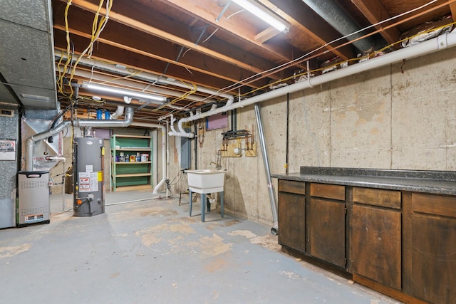 unfinished basement with a sink, heating unit, and gas water heater