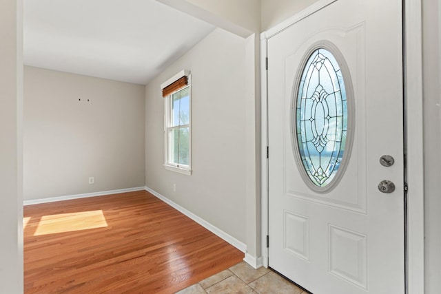 foyer entrance featuring baseboards and light wood-type flooring