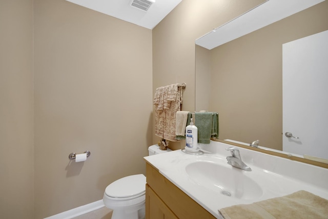 bathroom featuring toilet, visible vents, and vanity