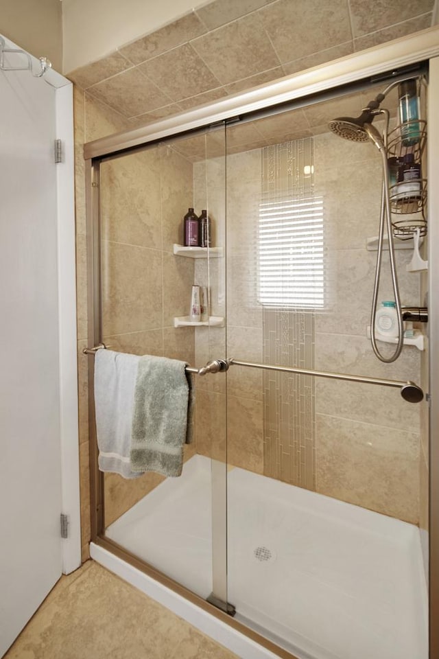 full bath with a shower stall