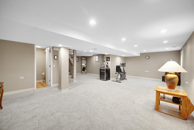 interior space with baseboards, light carpet, and recessed lighting
