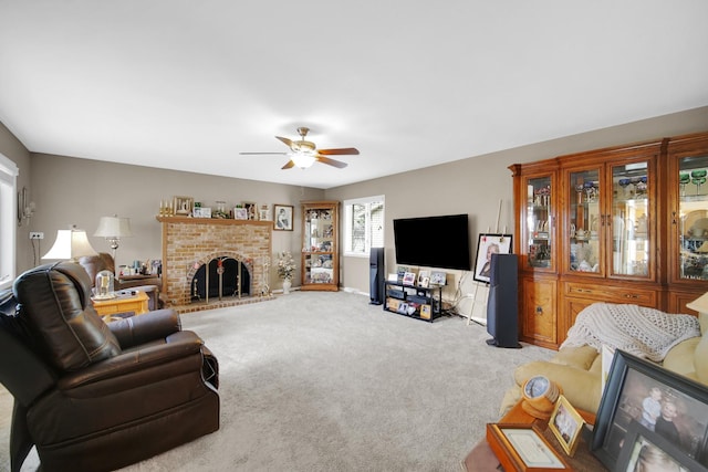 carpeted living room featuring a ceiling fan and a brick fireplace