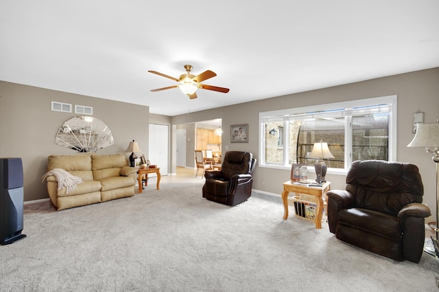 living room featuring visible vents, a ceiling fan, carpet, and baseboards