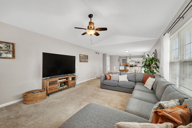 carpeted living room featuring baseboards, a ceiling fan, visible vents, and vaulted ceiling