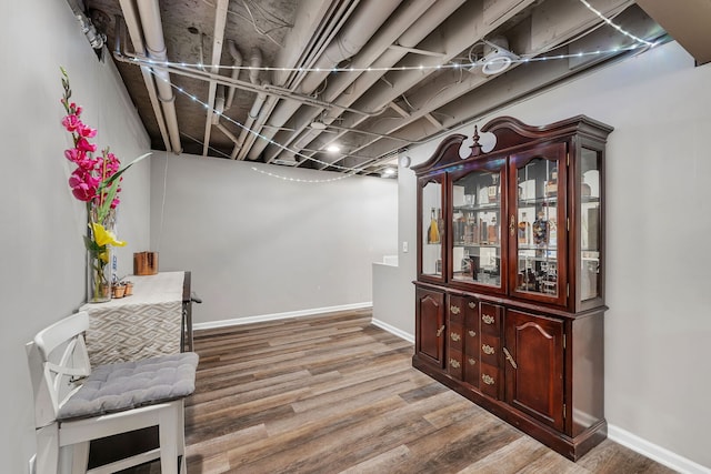 interior space featuring baseboards and wood finished floors