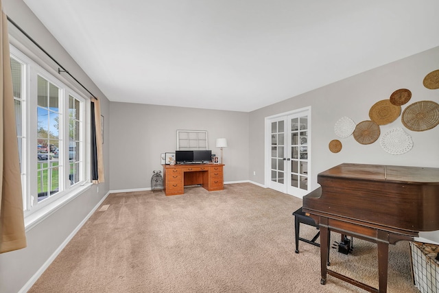 office space with baseboards, french doors, and light colored carpet