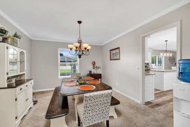 dining area featuring crown molding, baseboards, and a notable chandelier