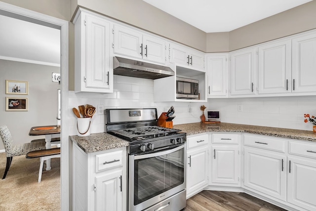 kitchen featuring under cabinet range hood, stainless steel appliances, and white cabinets