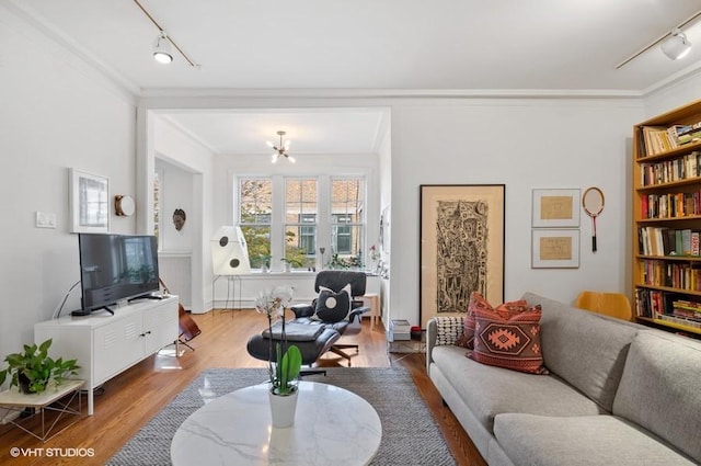 2311 N Commonwealth Ave Unit 3E, Chicago, IL 60614 - living room featuring an inviting chandelier, track lighting, ornamental molding, and wood finished floors