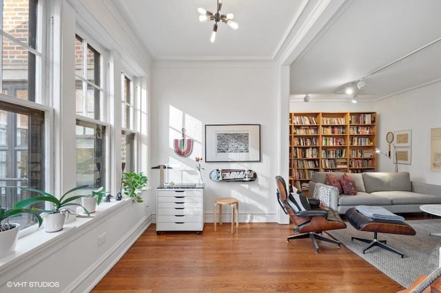 2311 N Commonwealth Ave Unit 3E, Chicago, IL 60614 - sitting room featuring wood finished floors, crown molding, a chandelier, and a healthy amount of sunlight