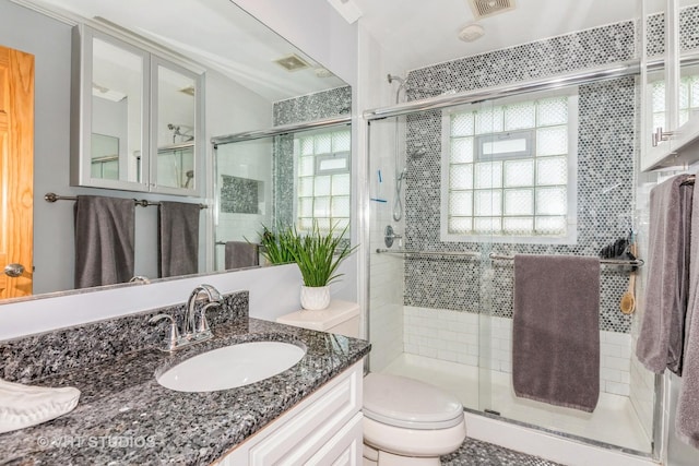 9459 Kelvin Ln Unit 2665, Schiller Park, IL 60176 - full bathroom featuring vanity, a shower stall, toilet, and visible vents