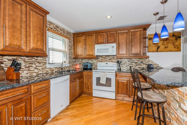 9459 Kelvin Ln Unit 2665, Schiller Park, IL 60176 - kitchen featuring a sink, a breakfast bar, white appliances, and brown cabinetry