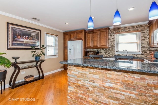 9459 Kelvin Ln Unit 2665, Schiller Park, IL 60176 - kitchen with visible vents, decorative backsplash, baseboards, light wood-style floors, and white refrigerator with ice dispenser