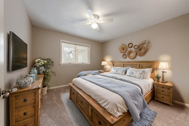 bedroom with baseboards, ceiling fan, and light carpet